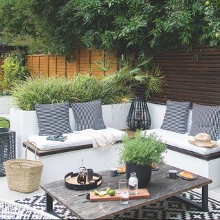 outdoor living room with bench seating and coffee table