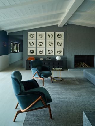 A blue living room with considered furniture