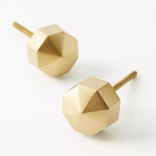 A pair of gold geometric knobs