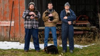 K. Trevor Wilson, Jared Kesso and Nathan Dales holding puppies on the farm in Letterkenny.