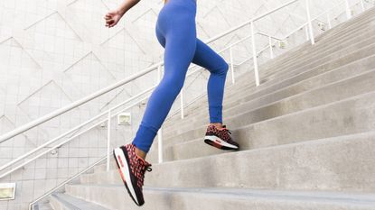 Why you should never diet and exercise at the same time: woman running up stairs