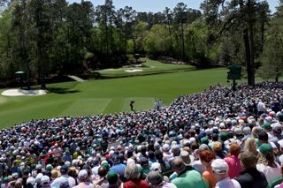 Tiger Woods tees off in front of packed crowds on the 12th at The Masters