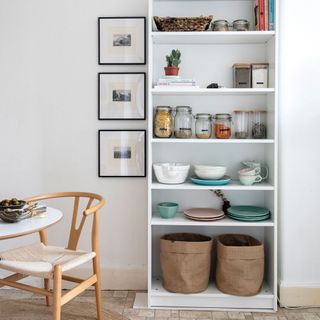 white room with shelving and table