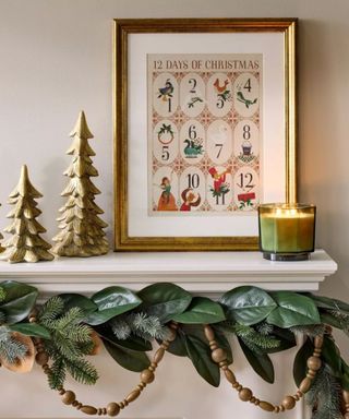 Christmas mantle with 12 days of Christmas print, magnolia and wooden beaded garland