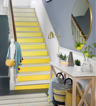 hallway with yellow painted staircase