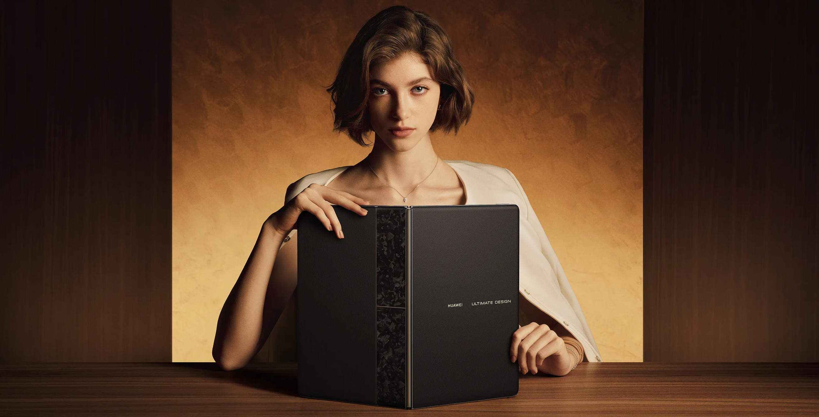 Female holding the new Huawei MateBook Fold Ultimate Design laptop
