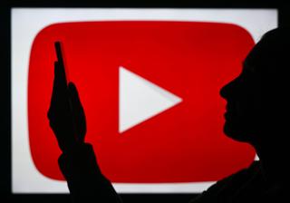 YouTube logo with a person watching a phone.
