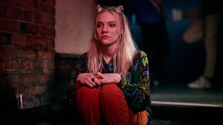 Robyn (Aine Rose Daly) sitting alone in the club in Boiling Point episode 4
