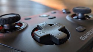 The GameSir G7 Pro's directional pad in the foreground, with its two analog sticks in the background
