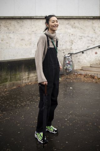 woman wearing overalls and sweater