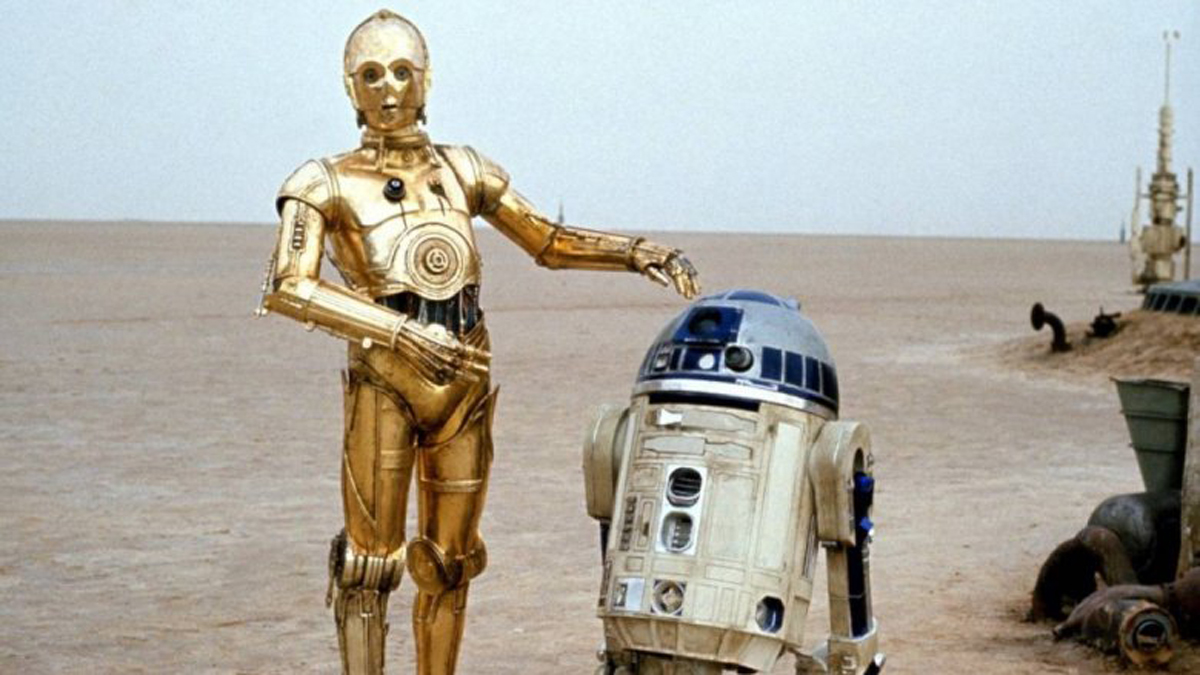 The Star Wars droids C-3P0 and R2-D2 in the desert of Tatooine.
