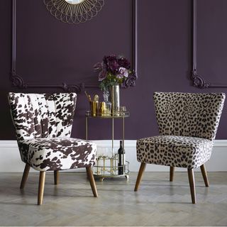 two cocktail lounge chairs in animal print with purple background cow print leopard print drinks trolley cocktails