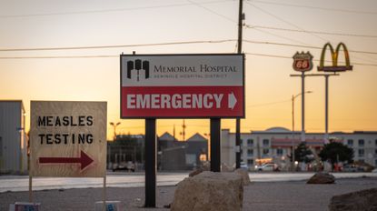 SEMINOLE, TEXAS - FEBRUARY 27: Signs point the way to measles testing in the parking lot of the Seminole Hospital District across from Wigwam Stadium on February 27, 2025 in Seminole, Texas. Eighty cases of measles have been reported in Gaines county with one death reported. 