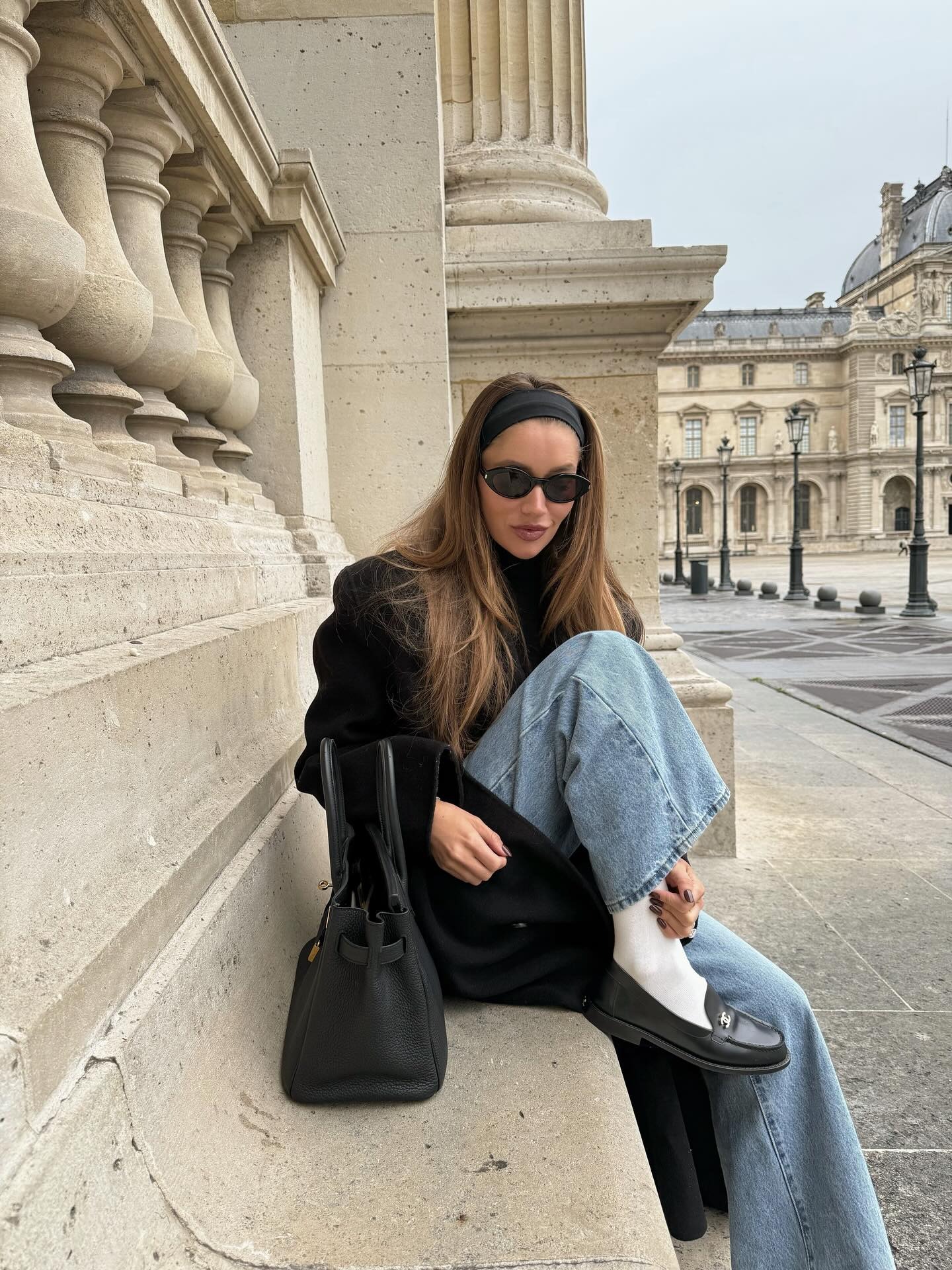 Photo of woman wearing light wash jeans in winter.