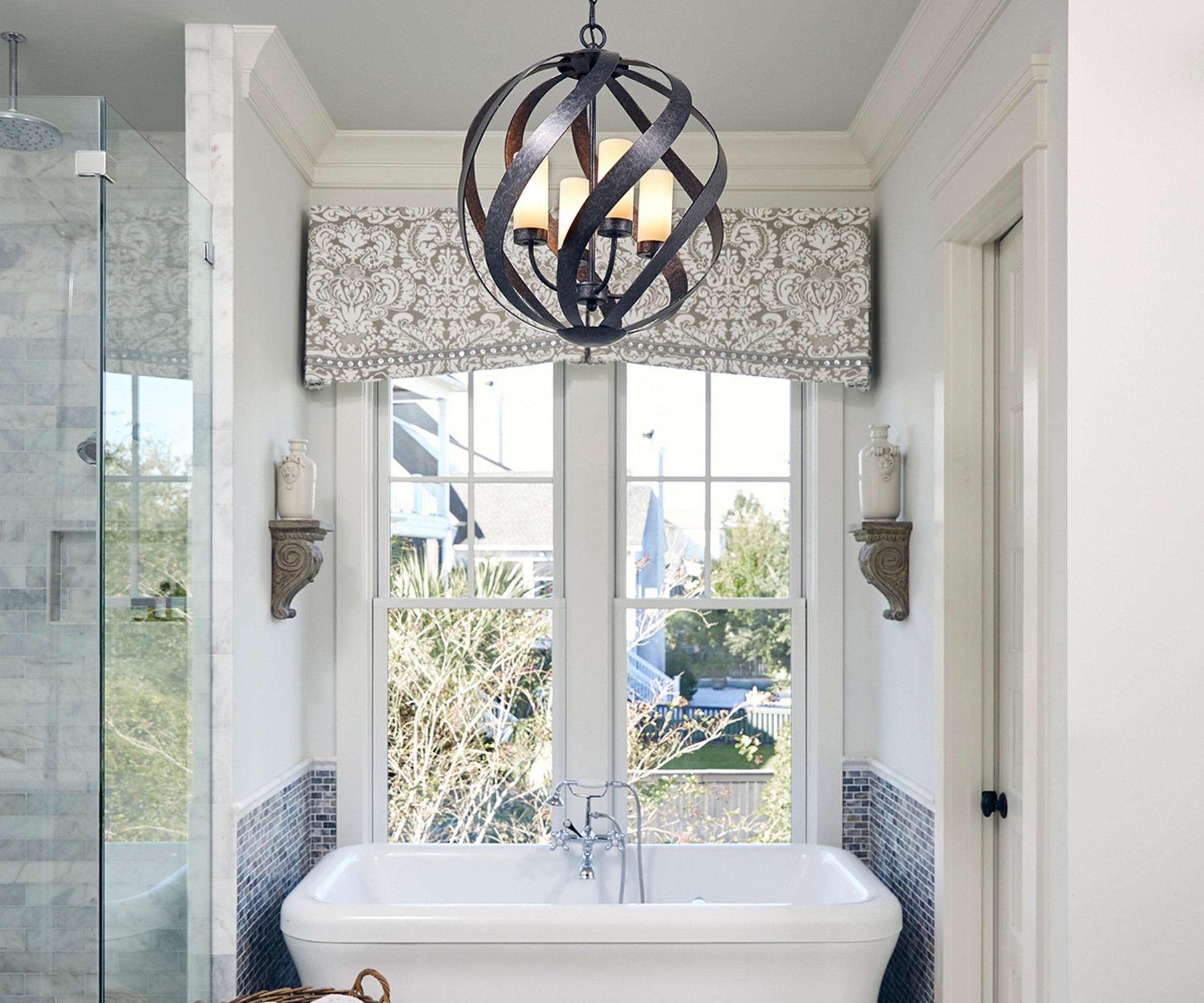 large metal pendant light in bathroom with shower and bath