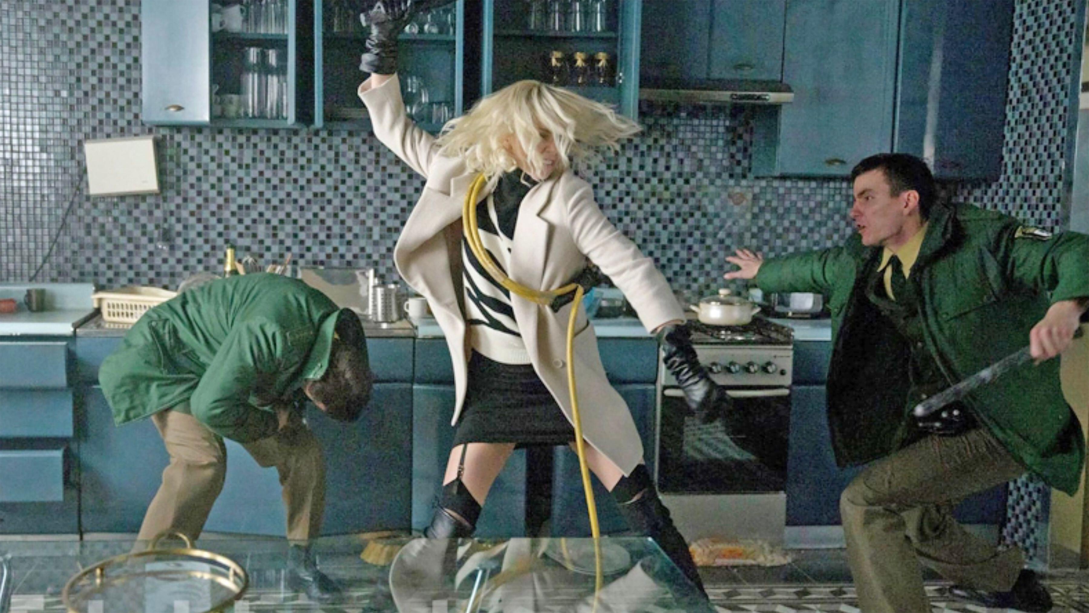 Charlize Theron as Lorraine Broughton fighting men in front of and behind her in Atomic Blonde
