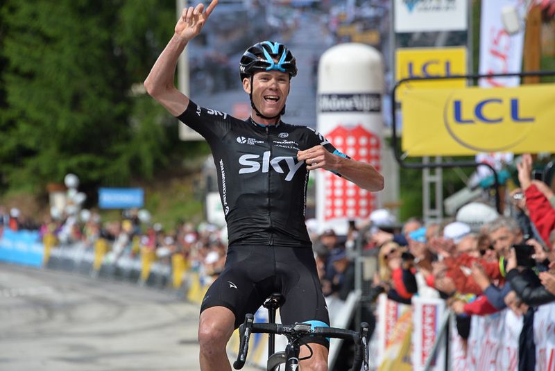Chris Froome points to the sky and to the team sponsor, Sky