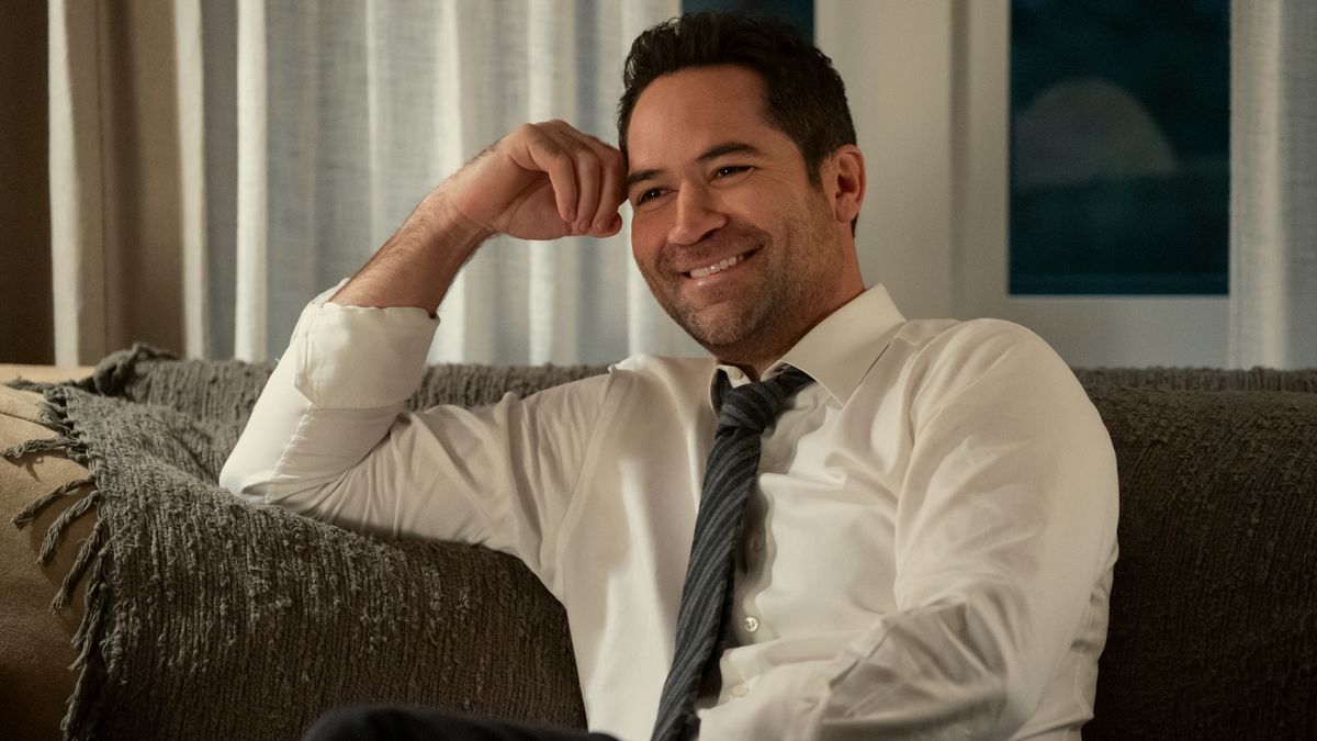 Mickey Haller (Manuel Garcia-Rulfo) sitting on a couch in &quot;The Lincoln Lawyer&quot; season 3