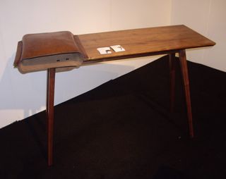 ﻿Leather and wood desk photographed against a white wall