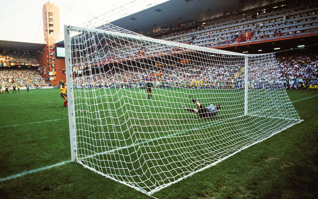 Packie Bonner of Republic of Ireland saves a penalty from Daniel Timofte of Romania during the penalty shoot out during the FIFA World Cup 1990 Round of 16 match between Republic of Ireland and Romania at the Stadio Luigi Ferraris in Genoa, Italy.
