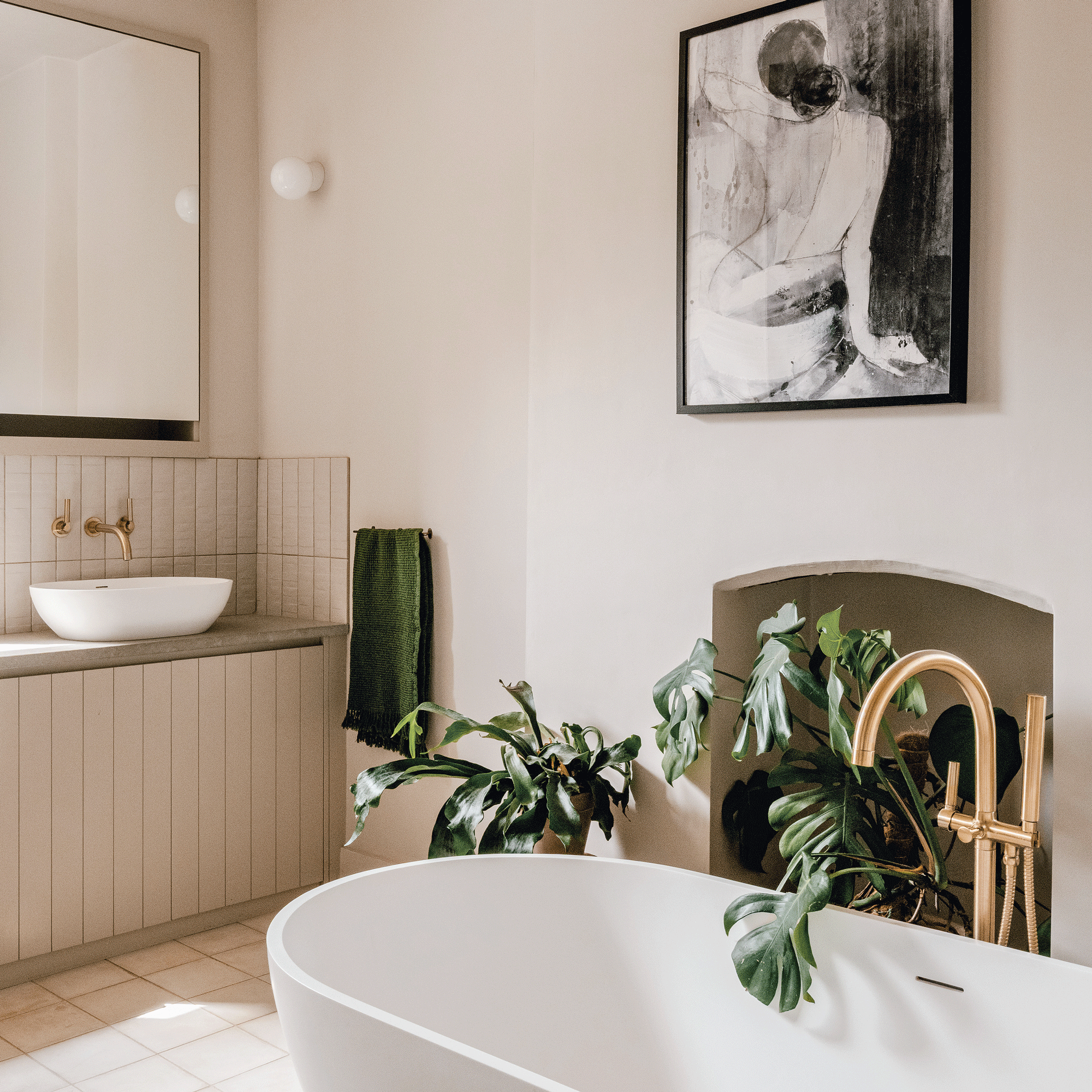 a neutral bathroom with a contemporary bath and matching basin and houseplants