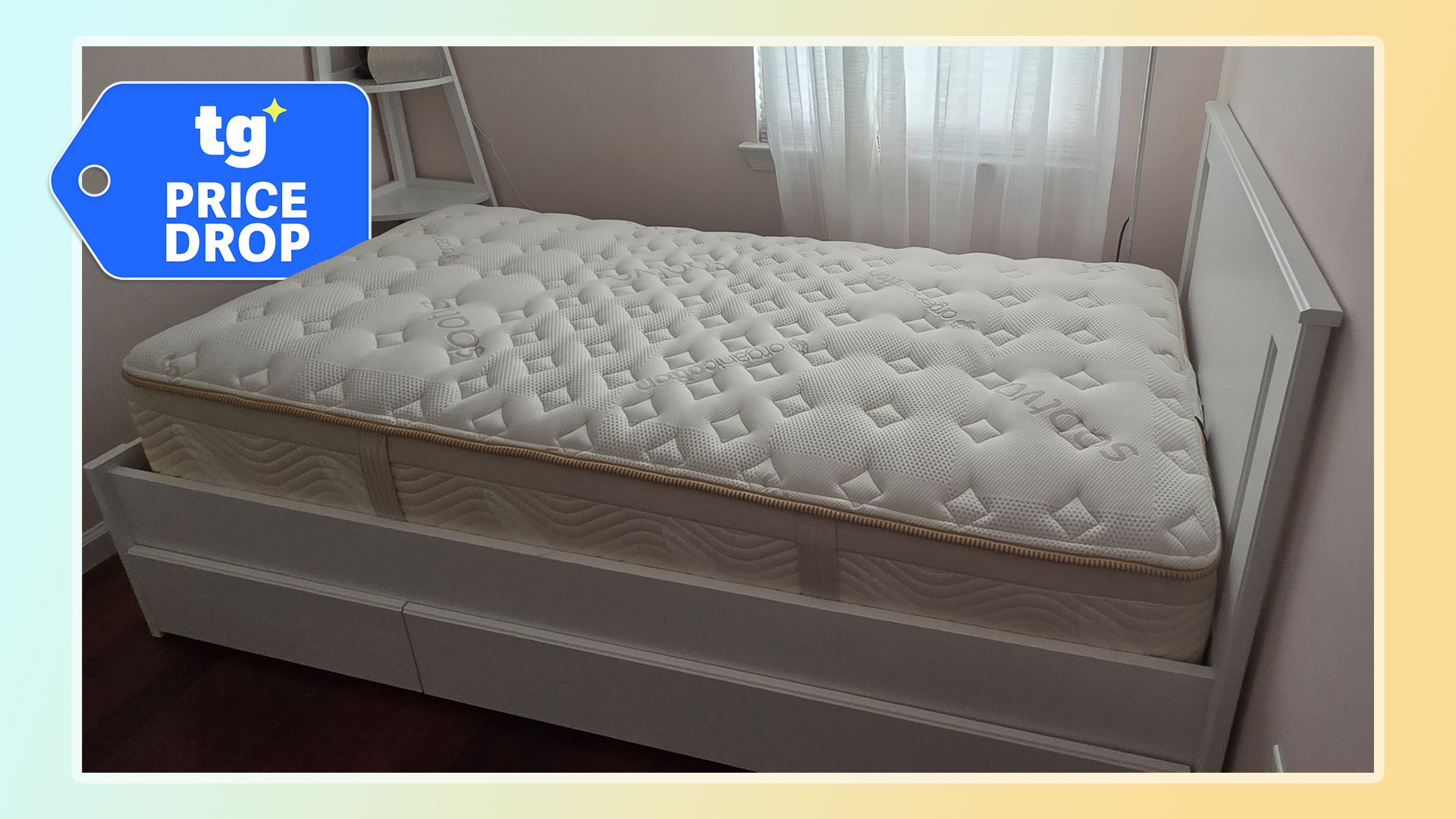 The Saatva Memory Foam Hybrid mattress in oour tester's bedroom, with a Tom's Guide price drop deals badge in the top left corner