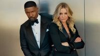 From left to right: Jamie Foxx standing and looking cool and Cameron Diaz leaning against him with her arms crossed. 