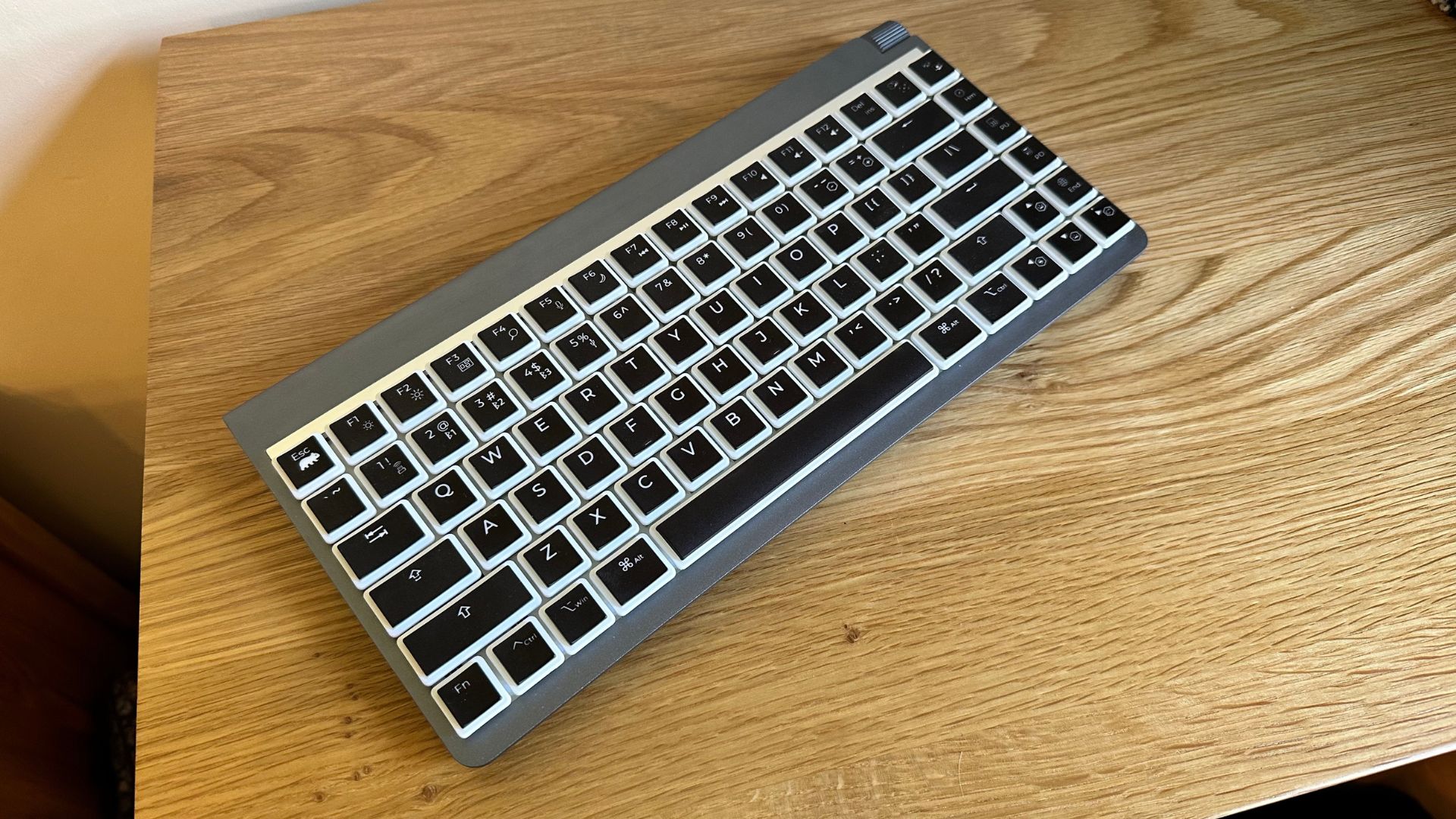 The Wombat Coleus mechanical keyboard on a wooden surface