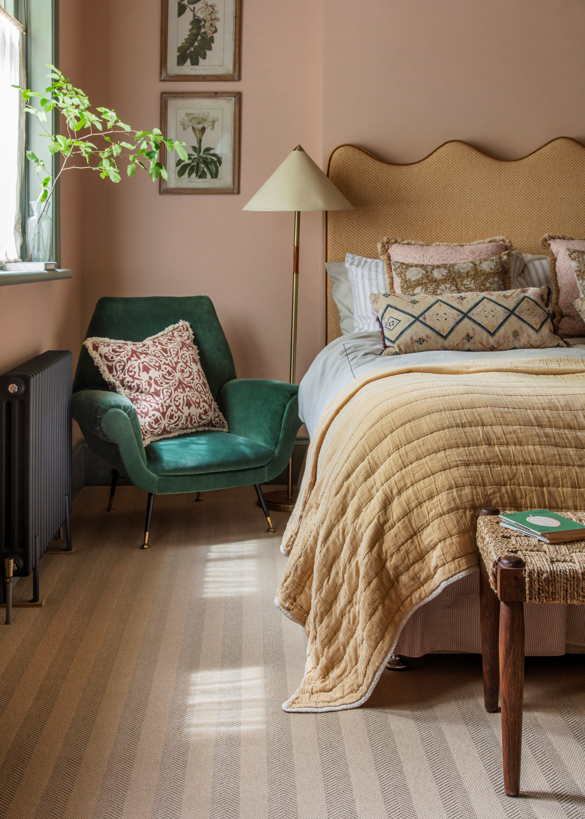 a cozy bedroom with striped carpeted flooring and a mustard yellow bed