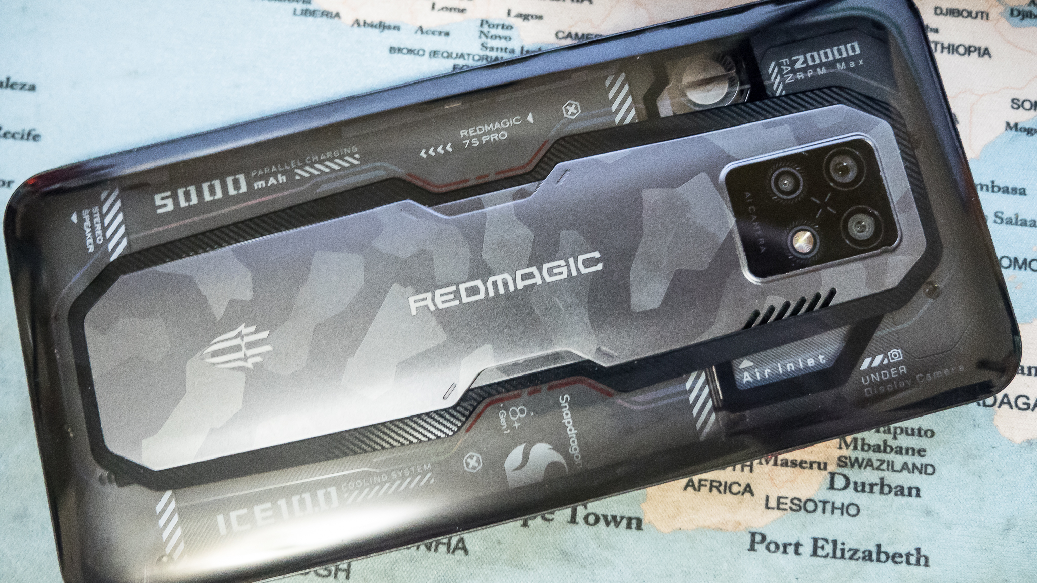 Red Magic 7S Pro lying flat on a map with its transparent back facing upwards