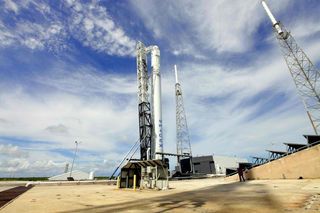 SpaceX Falcon 9 rocket poised to launch Dragon on 1st commercial cargo mission.