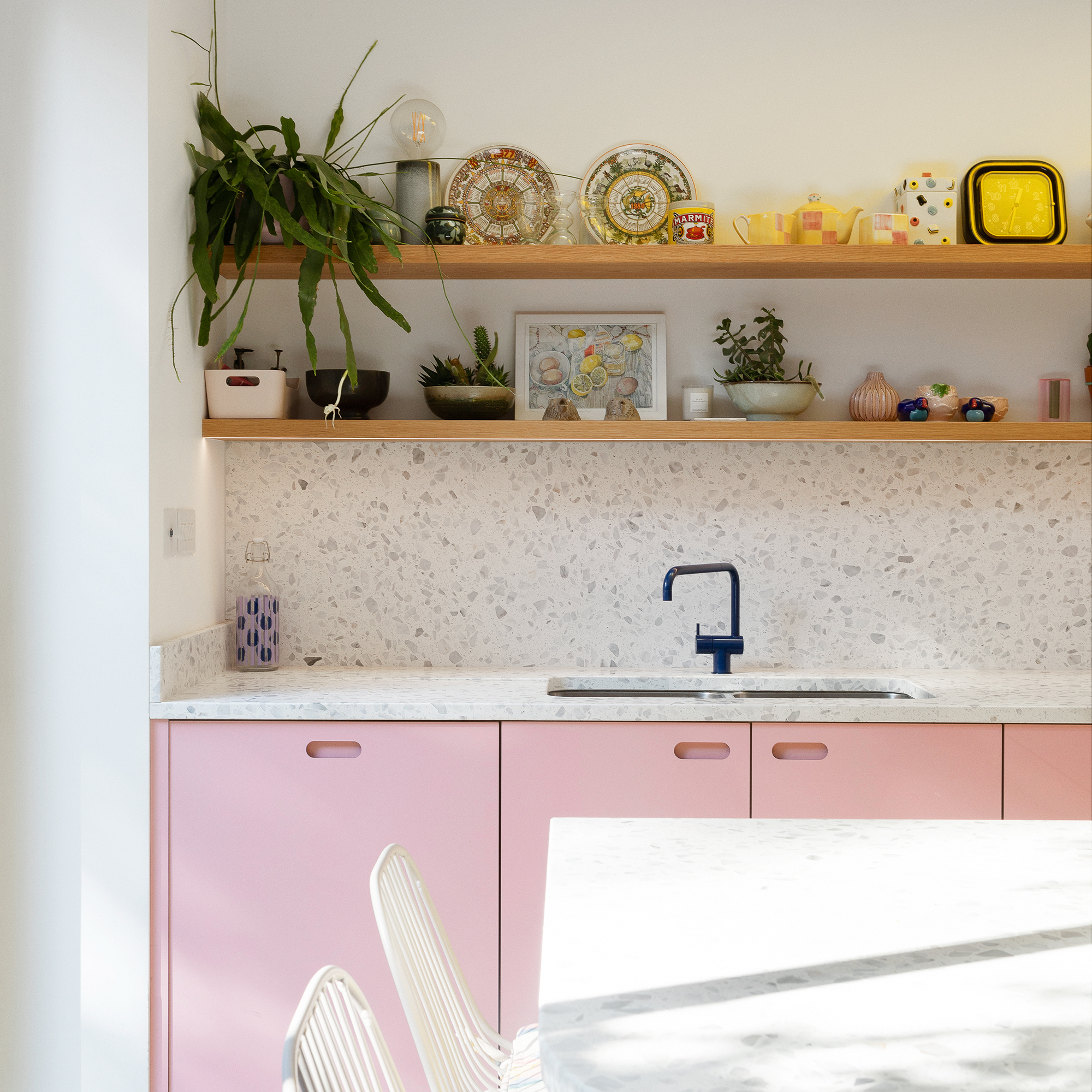 kitchen with pink cabinets terrazzo splashback open shelving