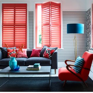 room with red shutters and sofa