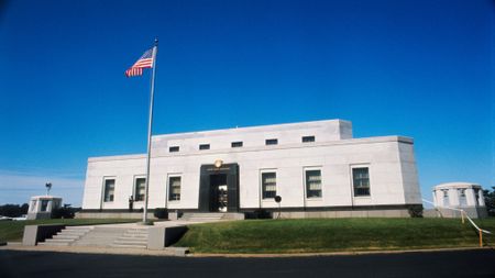 shot of the exterior of Fort Knox, with an American flag waving out front