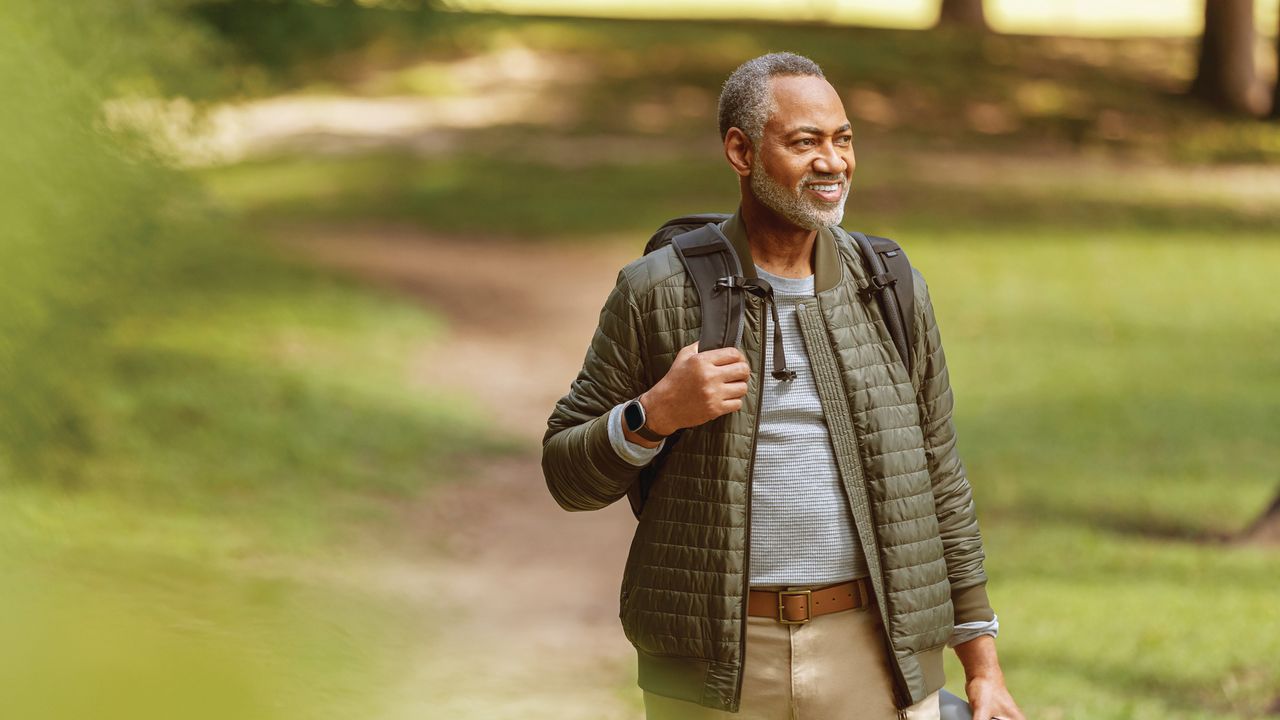 Man walking with Fitbit Sense