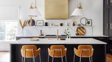 modern kitchen with black island, white walls and counters