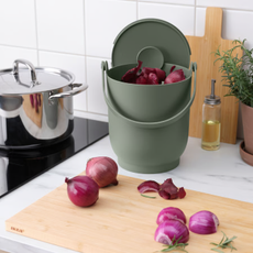 IKEA FARMARKVAST bin holding red onion peelings.