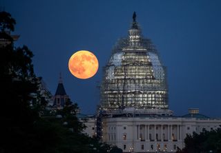 The Blue Moon of 2015 - the second full moon in July - shines bright next to the U.S. Capitol on July 31, 2015 in this photo by NASA photographer Bill Ingalls in Washington, D.C.