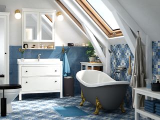 blue bathroom with patterned tiles and a grey freestanding bath