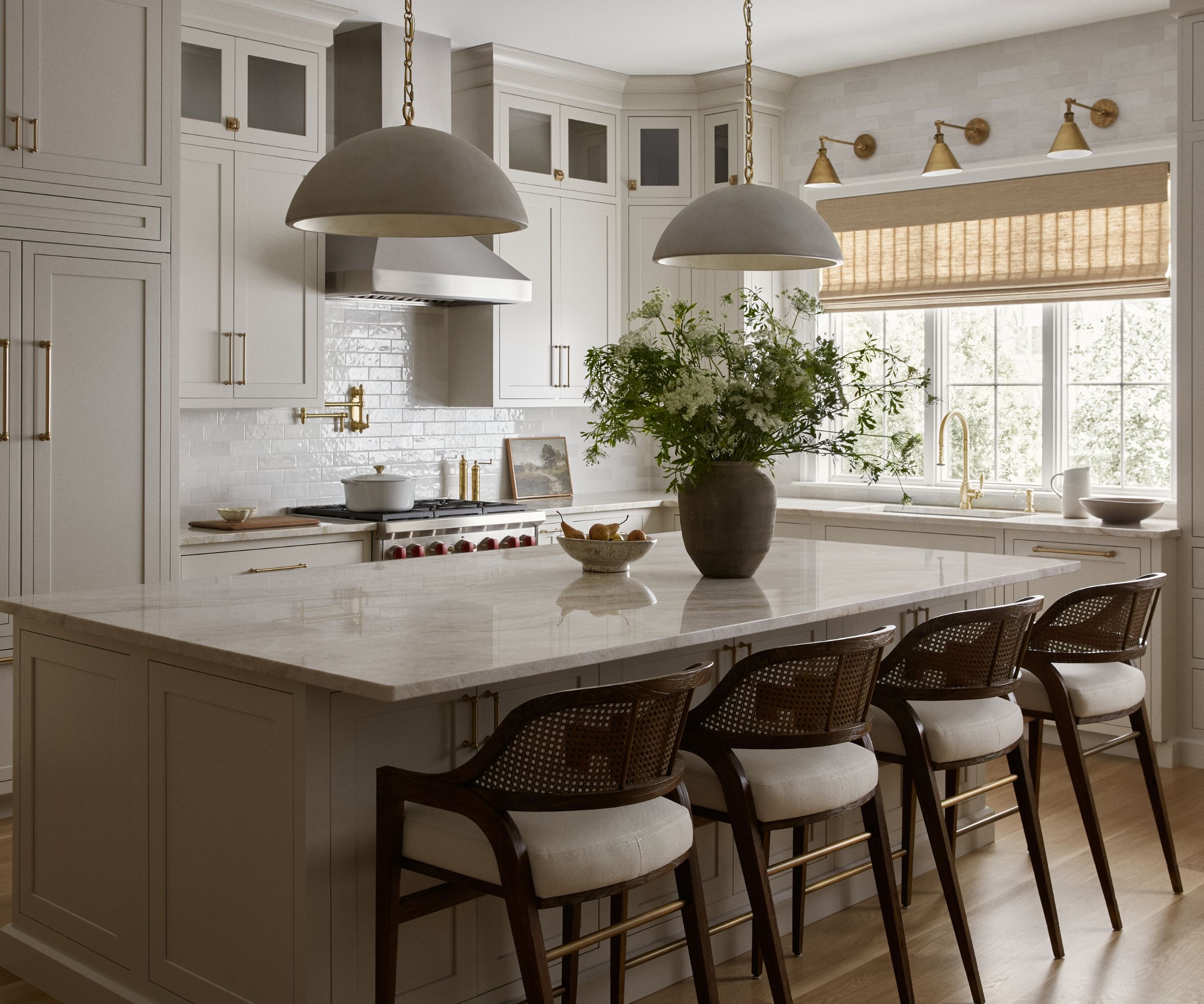 A subtle coastal kitchen with cream cabinets, blue accessories, and natural window treatments