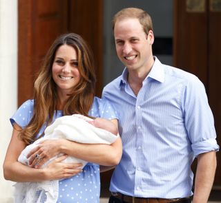 Prince William and Kate Middleton holding newborn son Prince George