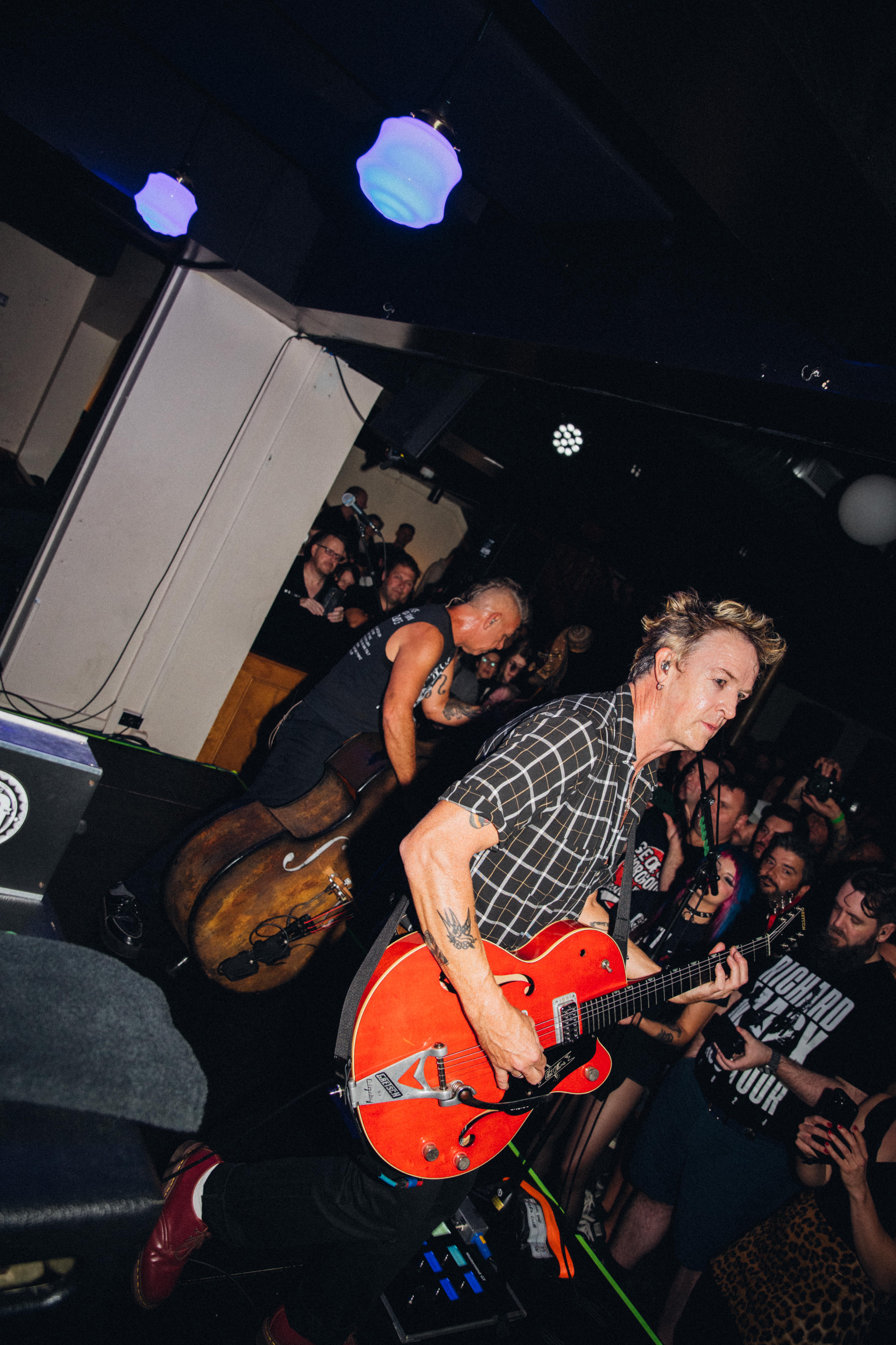 Chris Cheney and Scott Owen of the Living End playing in a tightly packed room