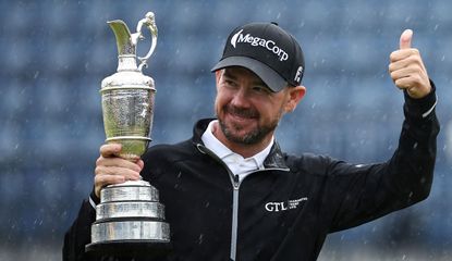 Brian Harman puts his thump up whilst holding the Claret Jug