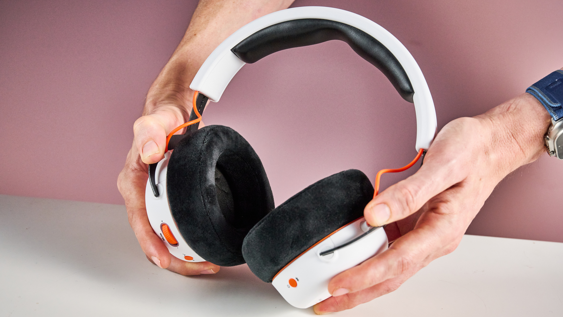The Beyerdynamic MMX 150 Wireless held in a man&#039;s hands, showing the inside of the cups.