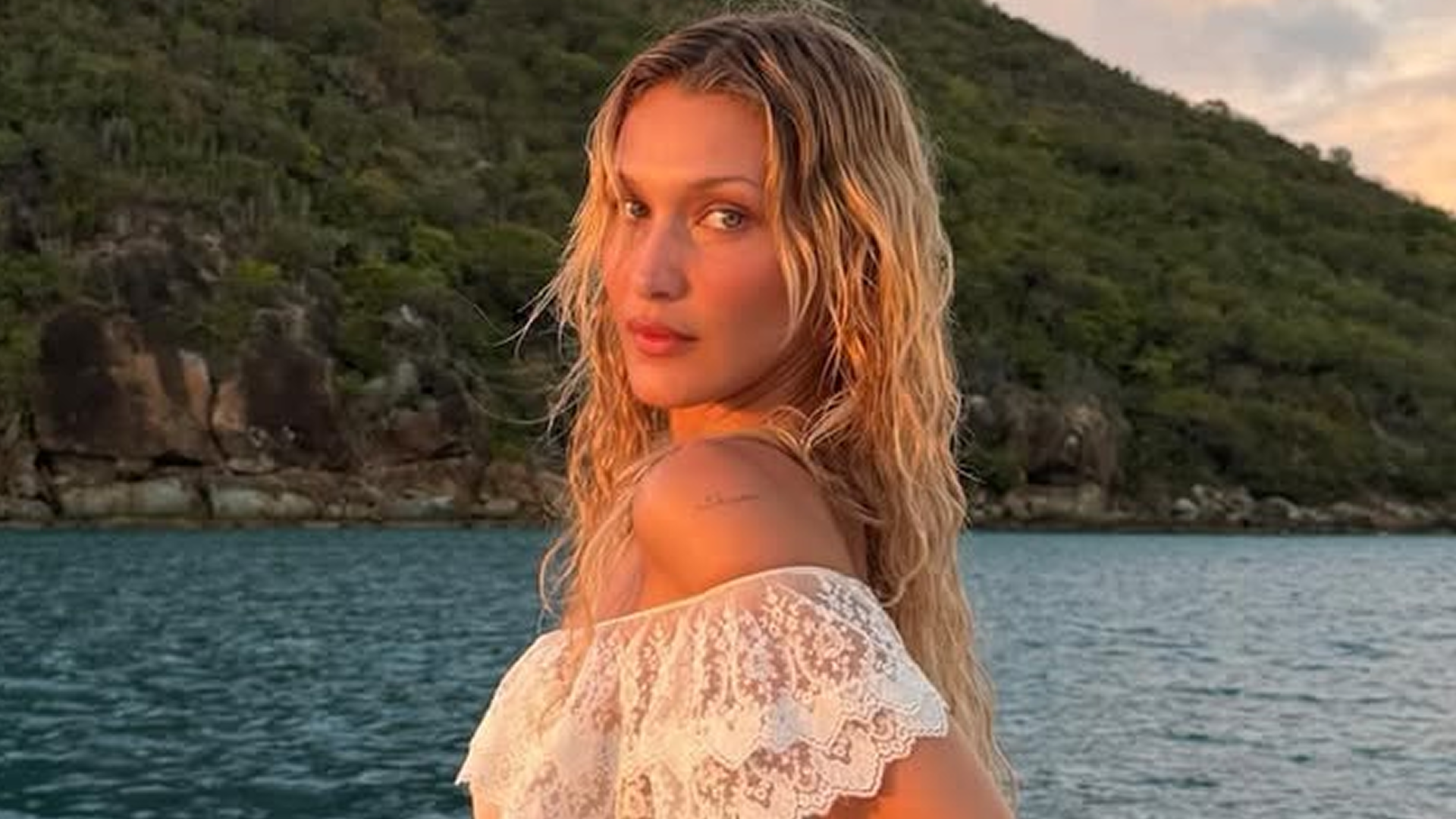 Bella Hadid posed on a yacht in a semi-sheer slip dress worthy of the mermaid summer trend