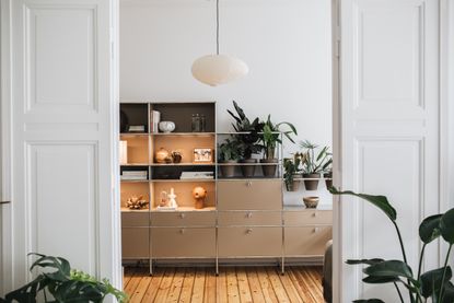 brown shelving unit in a white living room