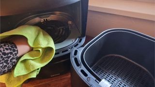 Air fryer heating element being cleaned