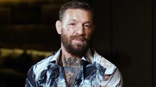 Conor McGregor smiling for the camera.