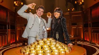 Harry celebrating his win stood next to the pile of gold and Claudia Winkleman for The Traitors season 2.