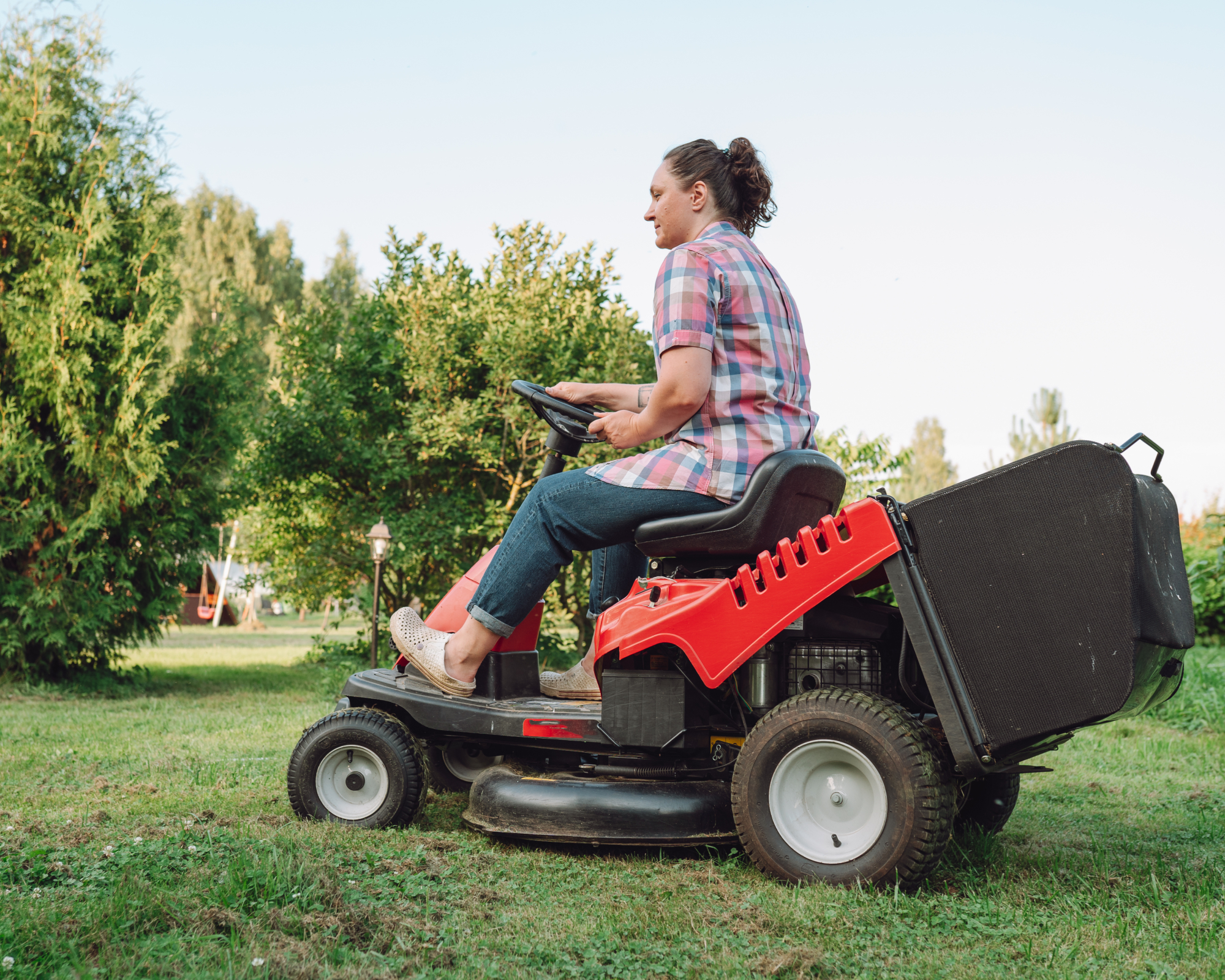 woman on riding mower in yard